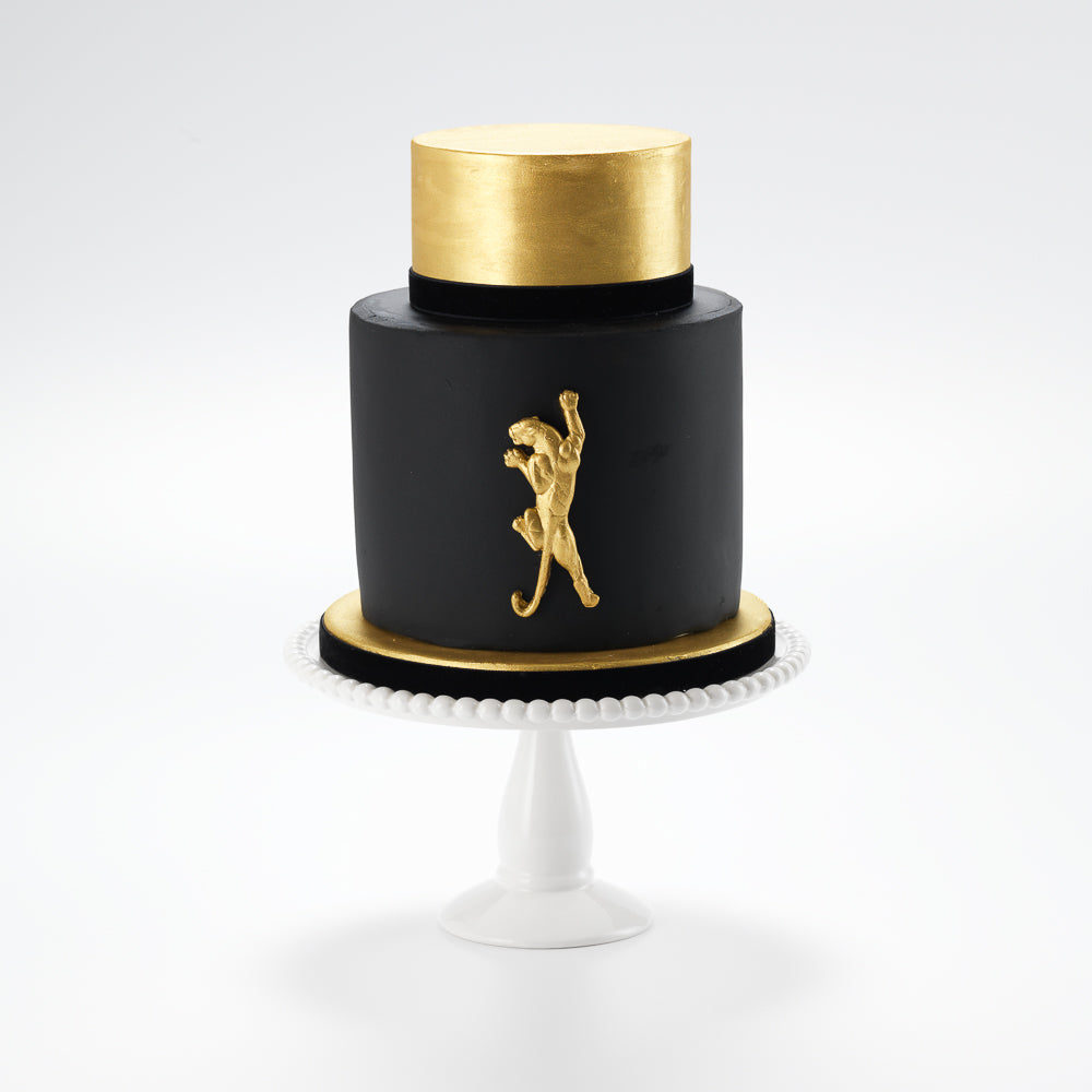 A sophisticated mans cake.The legendary panther is immortalised in gilded sugar on this luxurious gold and black iced cake. The Panther is by all accounts a  bold cake, sure to leave an impression on any occasion. 